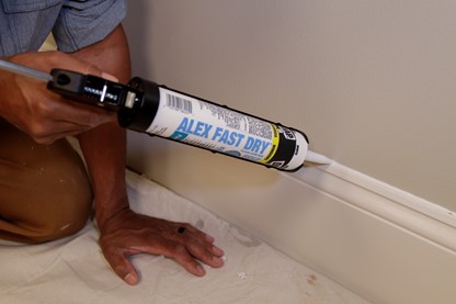 caulk along baseboard